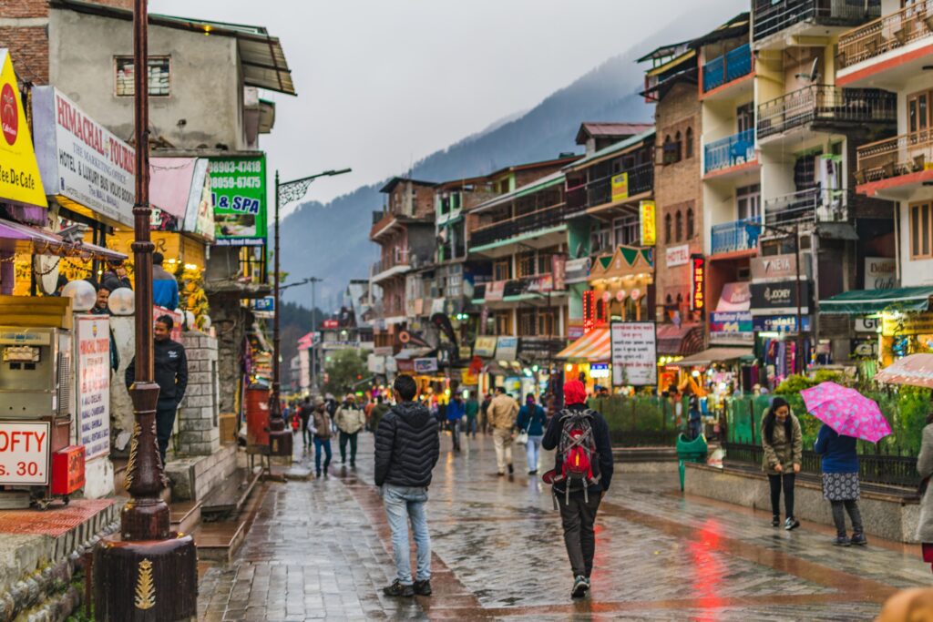 Old Manali hippie street with cafes, shops and mountain views - bohemian travel experience in Himalayas