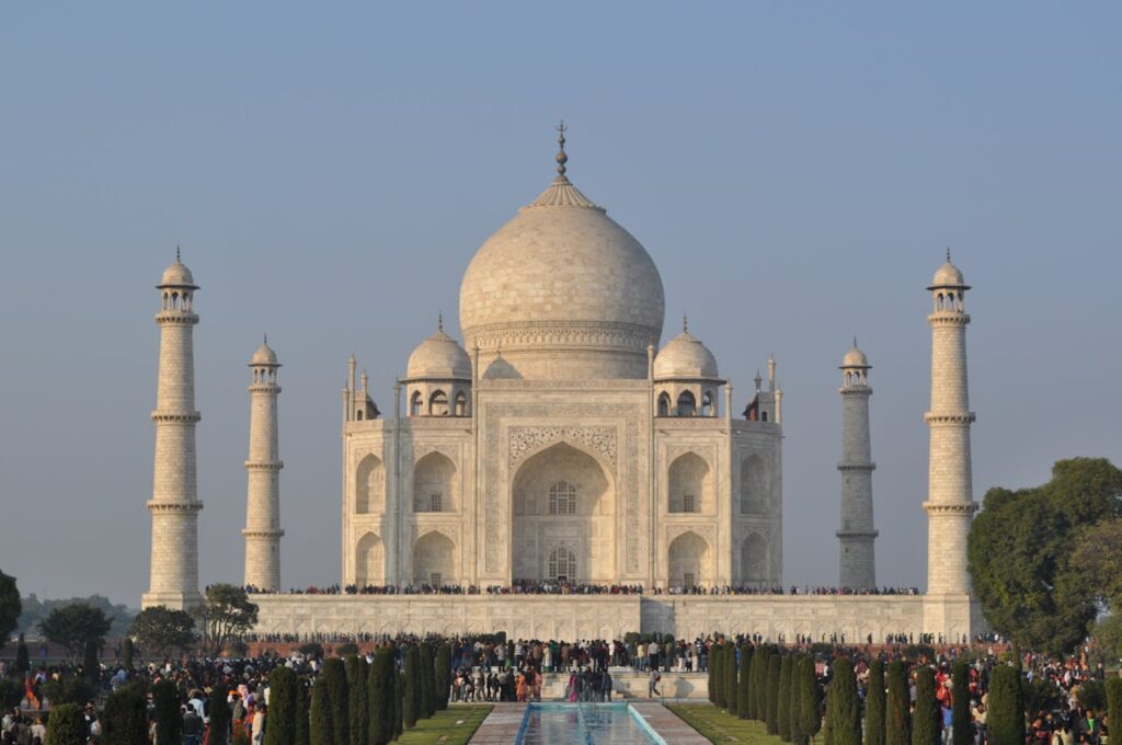 Sunrise view of the Taj Mahal reflecting in water, Agra - iconic India UNESCO heritage site for cultural tours.