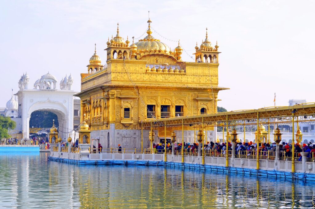 Golden Temple Amritsar tour package view with pilgrims at Harmandir Sahib