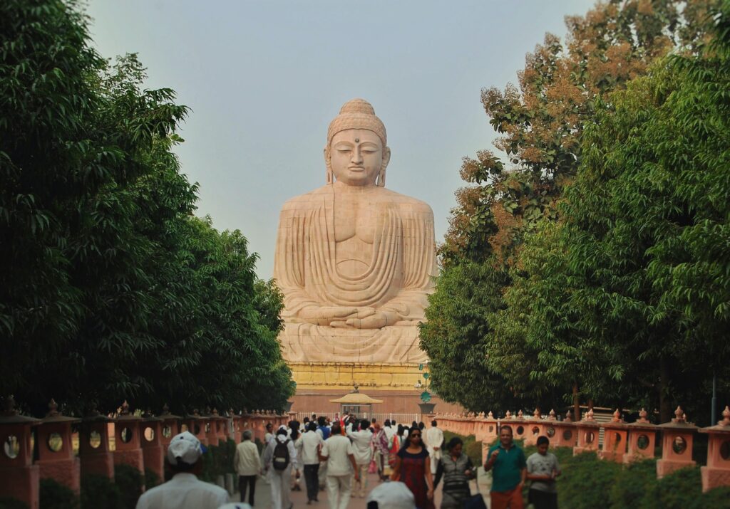 Shamrock Journeys guide leading a tour group to the Great Buddha Statue in Bodhgaya.