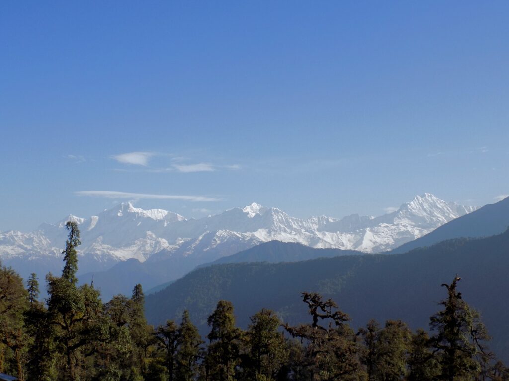 Panoramic view of snow-capped Himalayan peaks in Uttarakhand, India - ideal cover image for a travel guide.