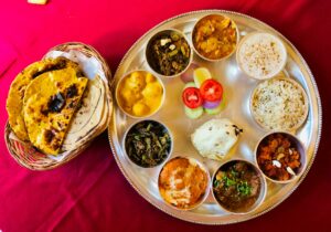 A traditional Indian thali meal with curries and bread, a culinary experience in Golden Triangle India.