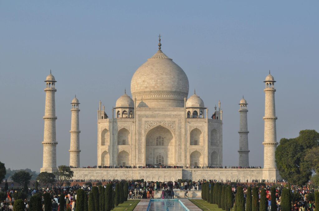 Traveler experiencing the Taj Mahal at sunrise as part of a combined cultural and spiritual tour of India.
