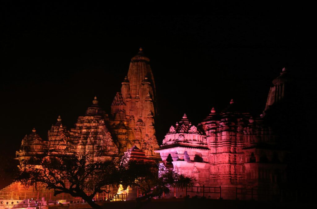 Visitors watching the dramatic Light and Sound Show at the Khajuraho temple complex, an evening highlight of Shamrock Journeys tour packages.