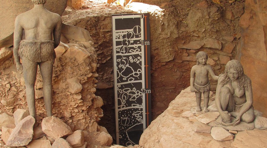 Prehistoric cave paintings depicting animals and hunters inside the Bhimbetka Rock Shelters, a UNESCO World Heritage Site.