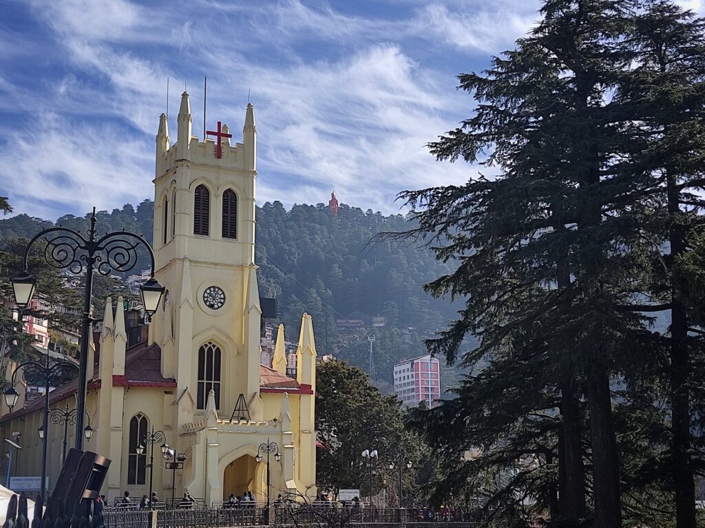 Panoramic view of Shimla hill station with colonial buildings nestled in green Himalayan mountains - perfect for family and honeymoon tours