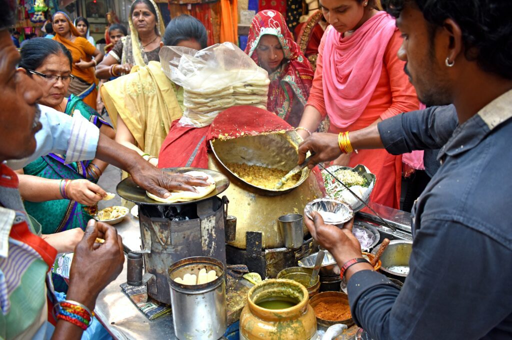 Vibrant street food scene in Chandni Chowk Old Delhi with traditional snacks and crowds