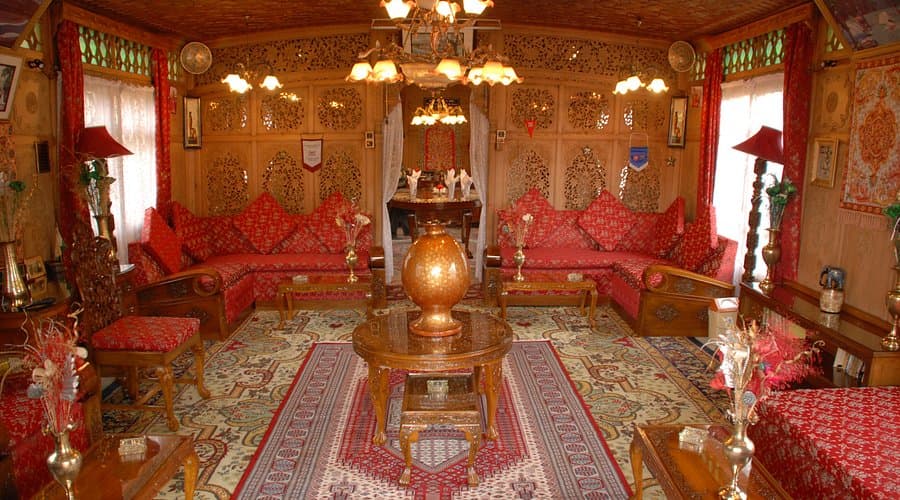Peaceful view of houseboat interior with wooden carvings on Dal Lake