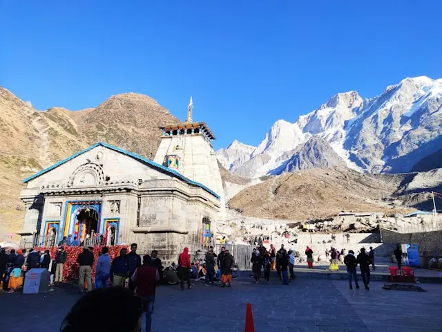 Pilgrims offering prayers at the sacred Kedarnath Temple during Chardham Yatra tour