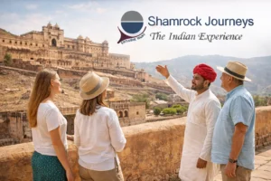 A small group of Shamrock Journeys travelers enjoying a guided tour with a local expert at the Amber Fort in Jaipur