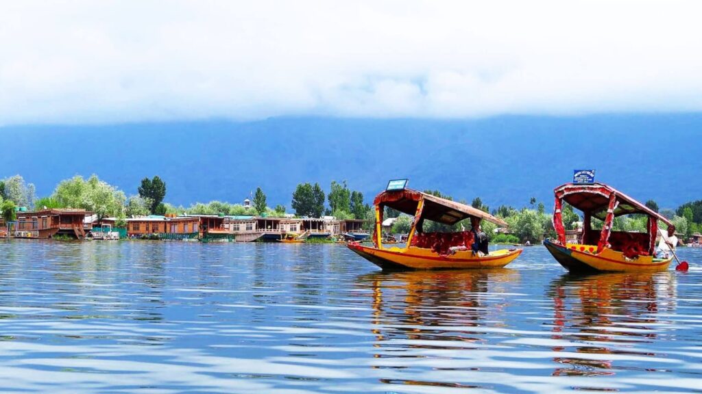 Traditional Shikara boat on Dal Lake, Srinagar with Himalayan mountains