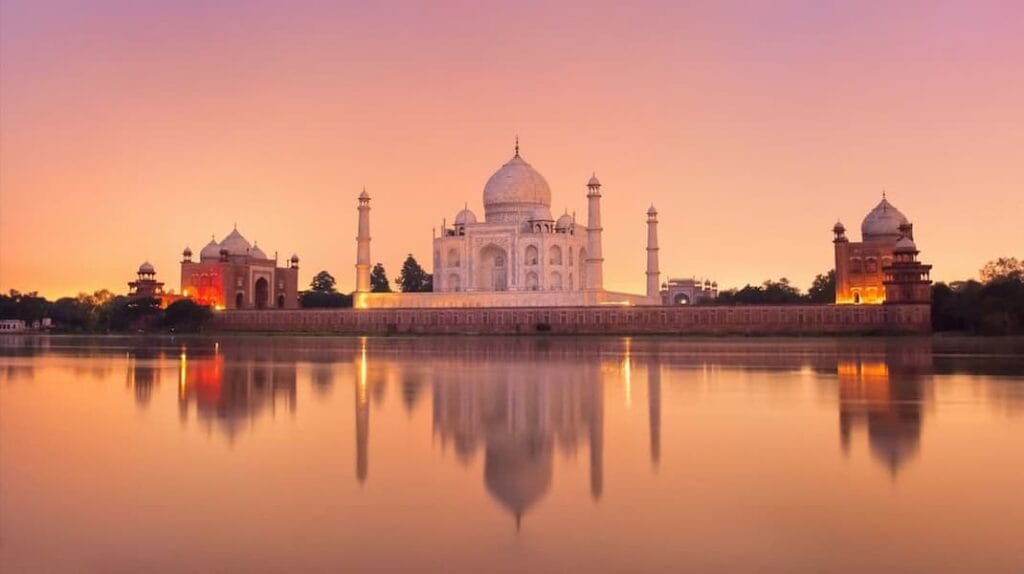 Sunrise view of the Taj Mahal reflecting in water, Agra - iconic India UNESCO heritage site for cultural tours