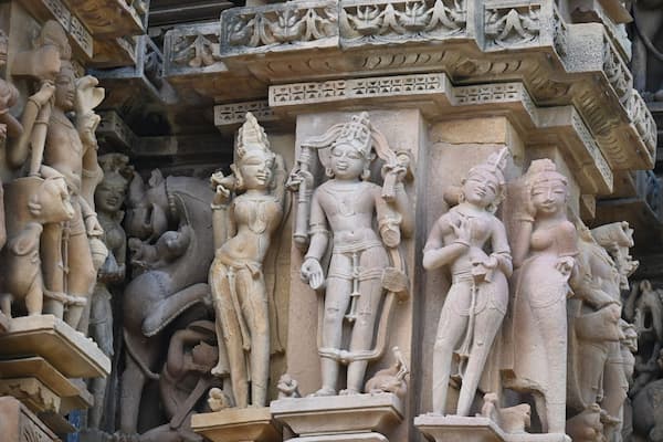 Fine stone carvings of dancers and gods on a Khajuraho temple wall