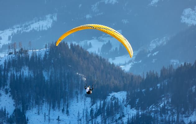 Paragliding over Solang Valley near Manali, with snow peaks behind, Himachal Pradesh