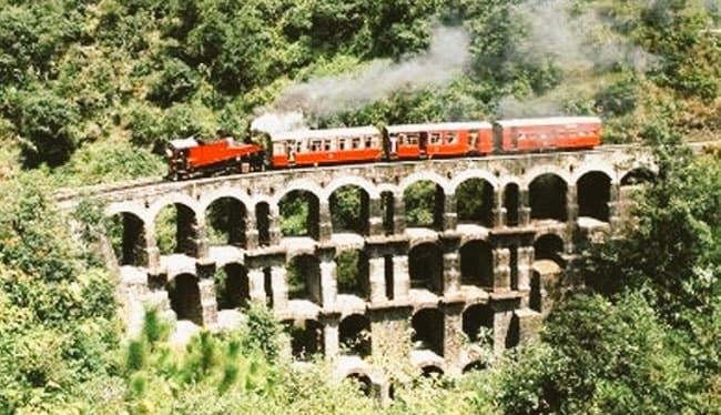 Toy train crossing an arched bridge on the Kalka-Shimla railway